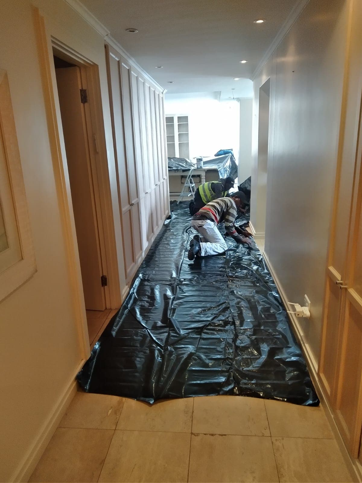 Floors covered with protective sheeting before painting starts