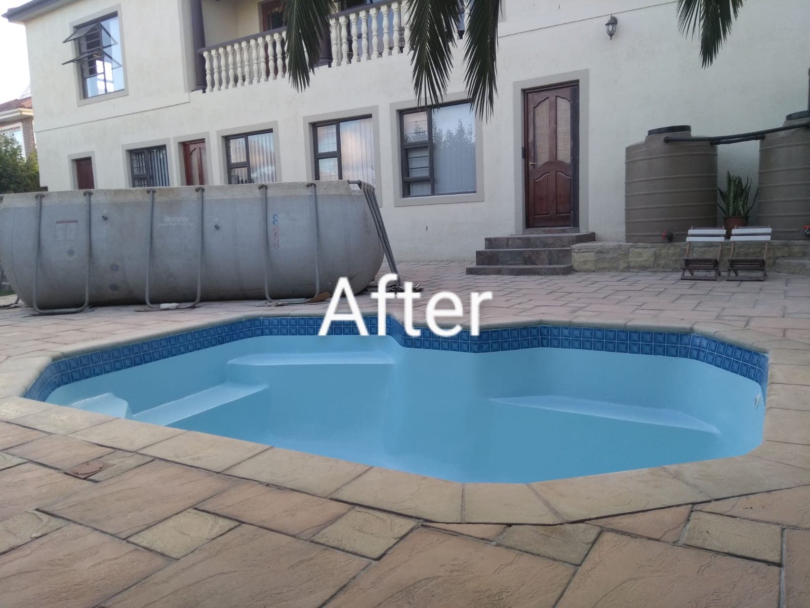 Renovated pool with fresh light-blue surface and new waterline tiles