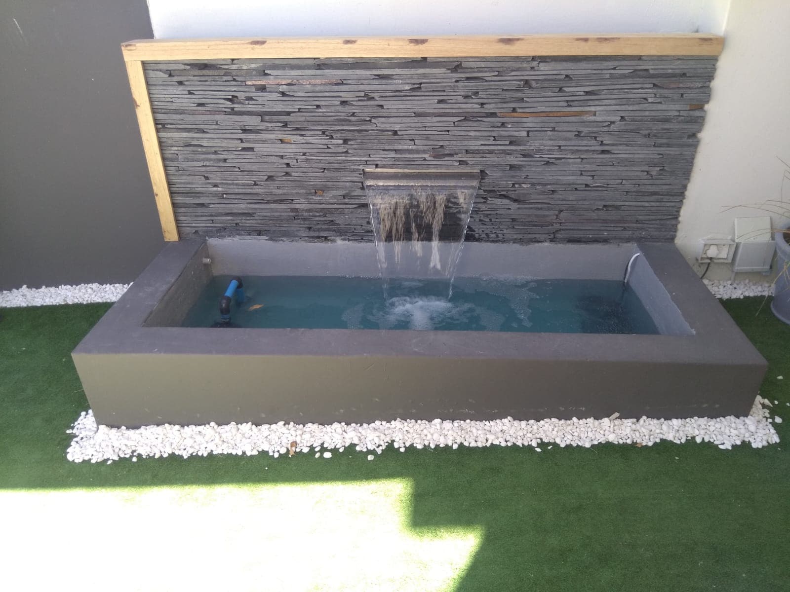 Slate stacked-stone water feature with waterfall built by Bruce Handyman