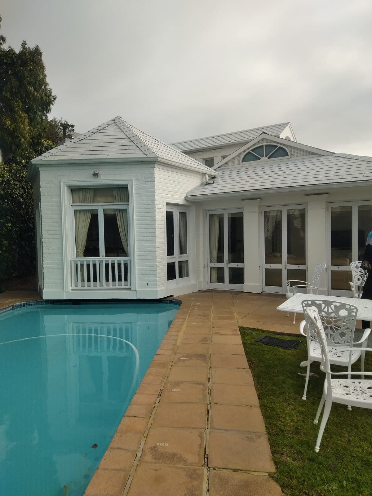 Elegant white house with pool maintained by Bruce Handyman