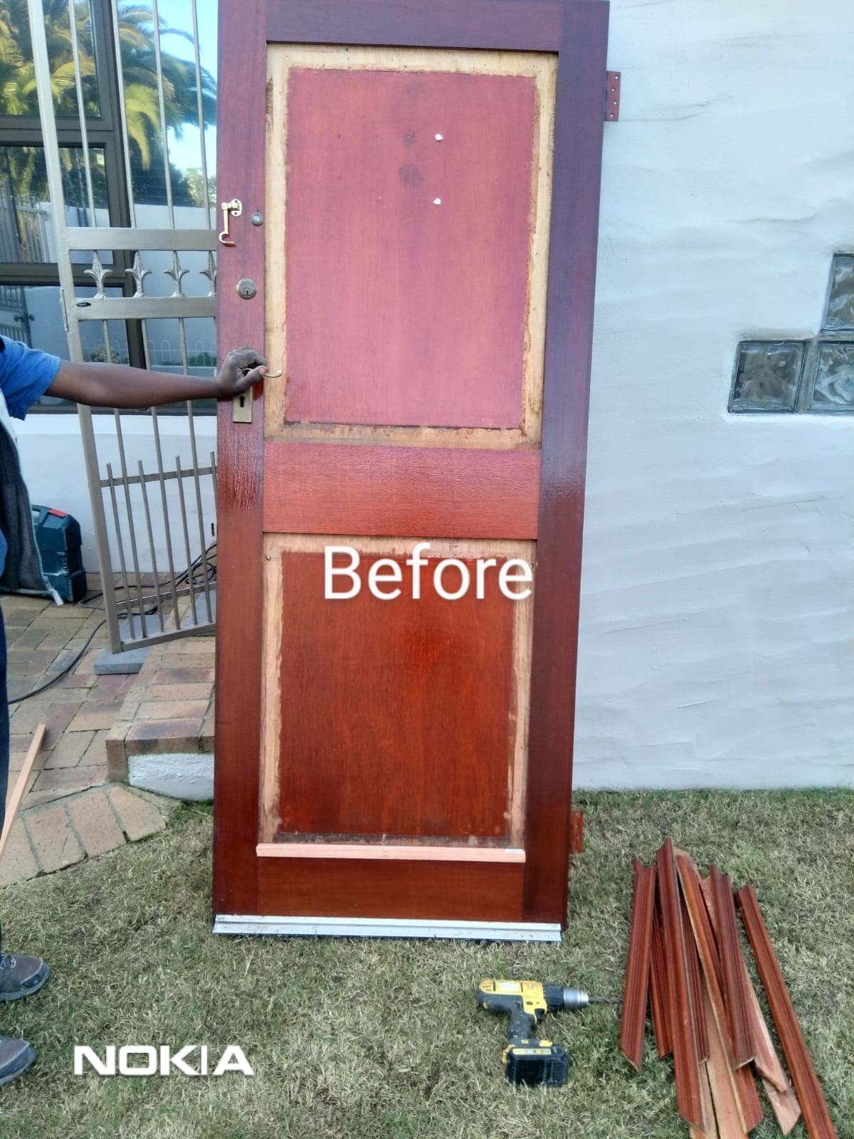 Front door stripped to bare wood before restoration