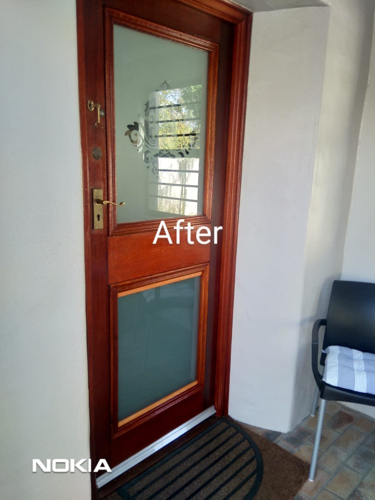 Restored mahogany front door with frosted glass panels and brass hardware